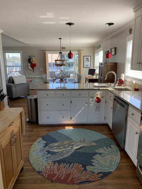 View from front door into the home; laundry closet off kitchen (to left)