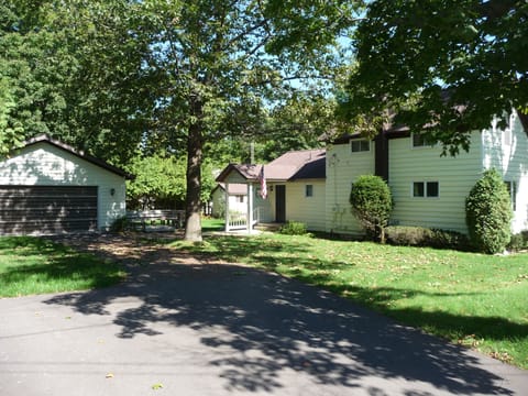 view of side yard and home from end of driveway.