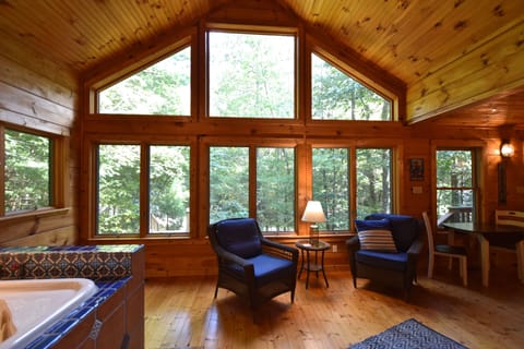 A beautiful sunroom with a view out into the private yard. 