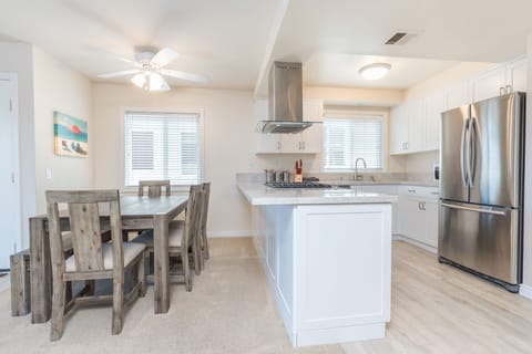 Family dining table sits adjacent to the kitchen on one side and living room on the other.