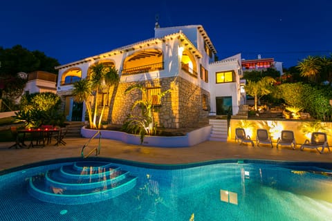 The house from the pool terrace at night