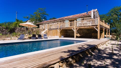 11x5m pool with large travertine bathing area, oak terrace and converted barn.