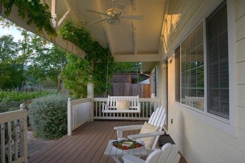 Adironack chairs and hanging swing on front porch