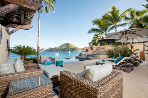 Spacious outdoor living area with comfy seating and loungers