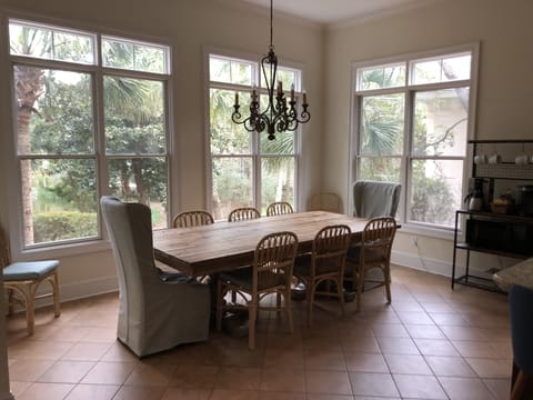 Gorgeous dining area overlooks lush pond complete with resident alligator.