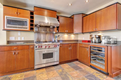 Wolf oven and stove. Kitchen is fully equipped with warmers and beverage frig