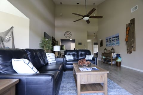 Living and dining rooms with new top grain leather sleeper sofa and love seat