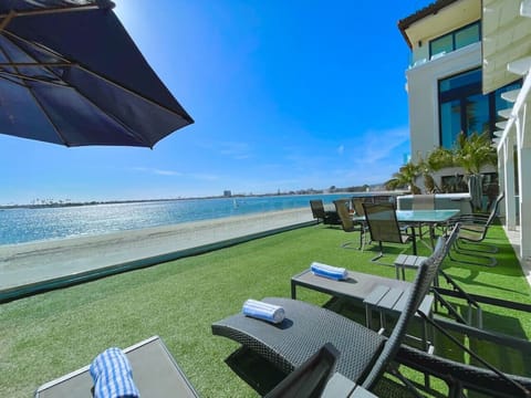 The yard is directly on the bay beach with a pathway for walkers, bikers, runners, skaters, etc! Dine outside, play games, lounge in the sun, sit by the fire, and relax in the hot tub!