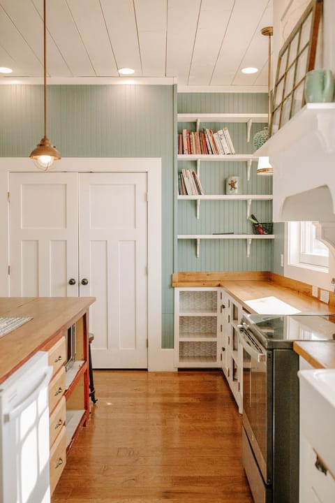 Kitchen with view of dishwasher, stove, and pantry