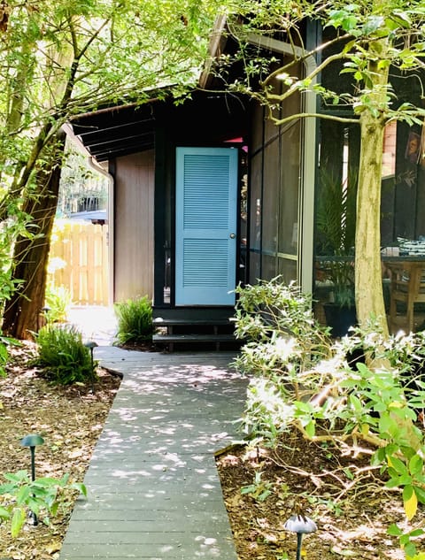 Private side entrance to the screened porch with living and dining areas.