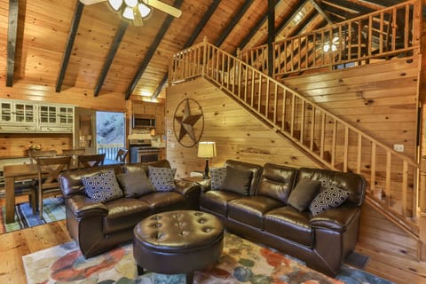 Sitting and dining area with steps up to the loft. 
