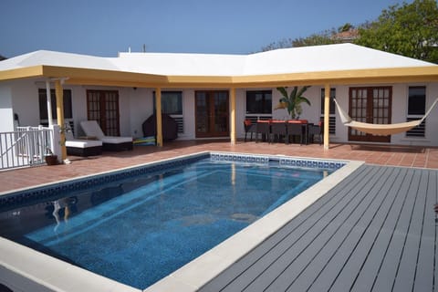 View of home's private exterior and pool.