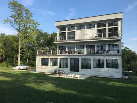 Lakeside with tons of windows, huge 2nd floor deck with couch, table, and grill.
