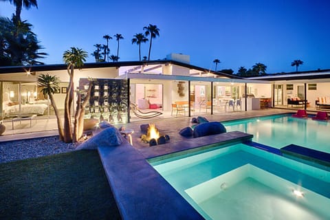 Spa and pool looking into the back of the house at dusk