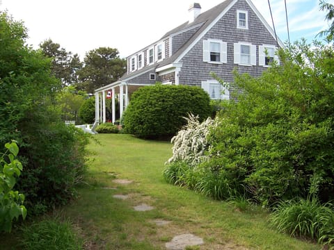 A flagstone walkway from the parking lot up to the house