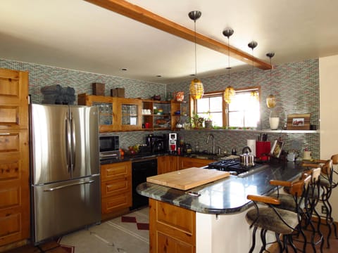 Kitchen on 2nd lvl. Glass tile walls, granite, stainless and Thermador gas range