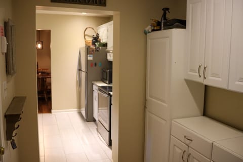 The main entryway leads to the kitchen and has cabinet space for storage.