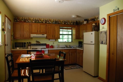 Well equipped eat in kitchen with easy access to the huge Creekside deck 