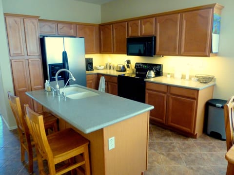 Well equipped kitchen with dimmable under cabinet and ceiling lighting.