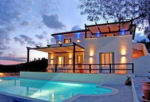 Nightime view of pool and villa