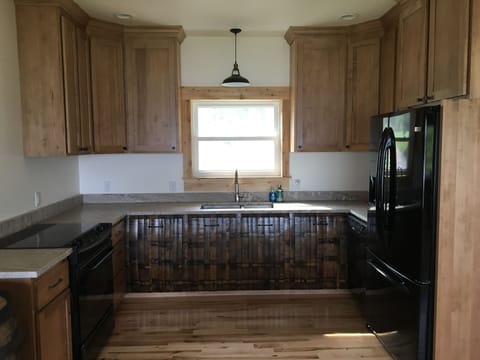 Kitchen with custom cabinetry and beer barrel feature 