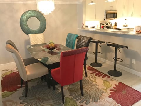 Dining table seats 6, breakfast bar seats 3.