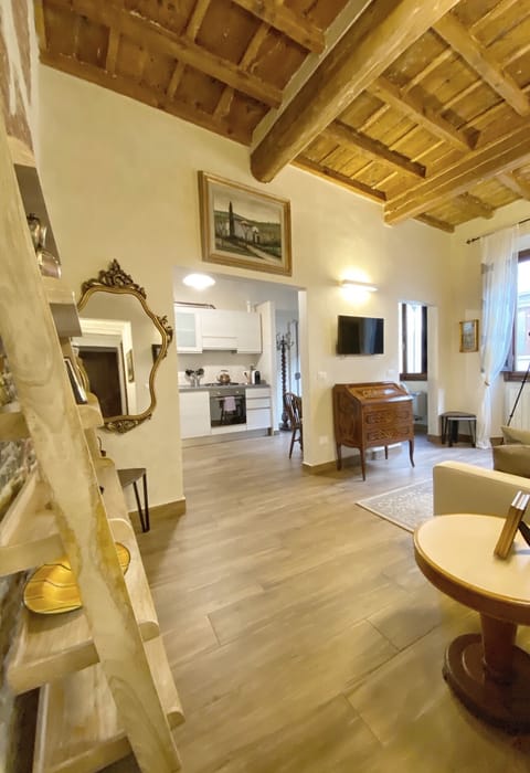 Living room with wonderful stone & brick wall from the 1400s and wood ceilings 