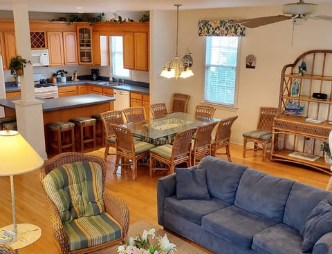 View from TV area toward main dining table and kitchen