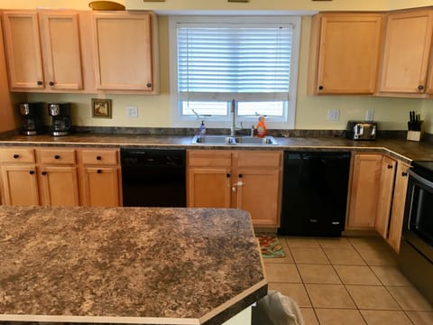 Kitchen with two dishwashers, two refrigerators