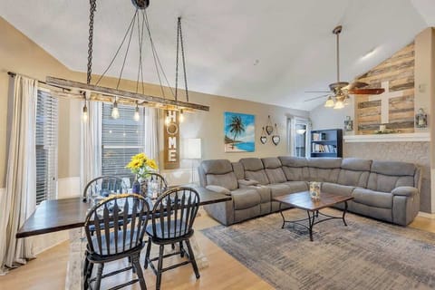 Beautifully decorated family room with large reclining couch w/massage & heater, 55" TV, sound bar, ceiling fan, farmhouse table and ladder chandelier (extra card tables & chairs in bedroom 4 closet).