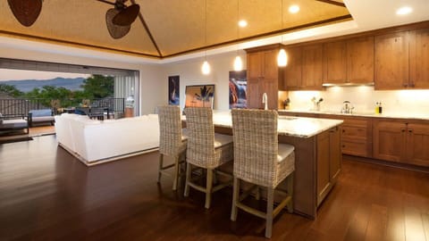 Open concept living room and kitchen with additional island seating