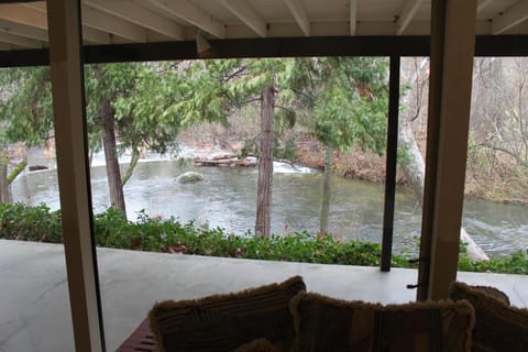 Family Room with Full Length Glass Wall and Porch Overlooking the River