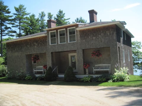 The house sits in a sunny location amid the pine trees.