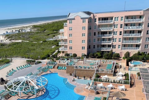From roof of OUR beach from building shows ocean front pool area & complex