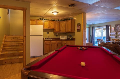 The lower-level game room includes a billiard table with kitchenette!