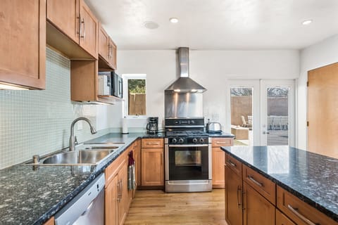 Custom granite counters and island, easy access to outdoor entertaining