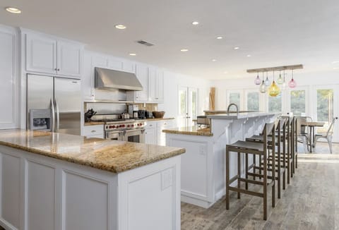 Gourmet kitchen: open, airy, fully stocked, 6 burner wolf range.