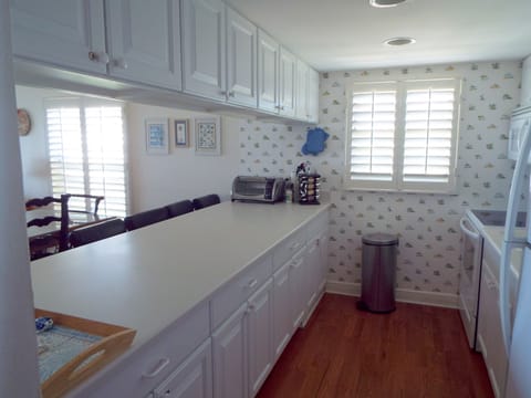 Bar stools at counter all new kitchen appointments wood flooring 