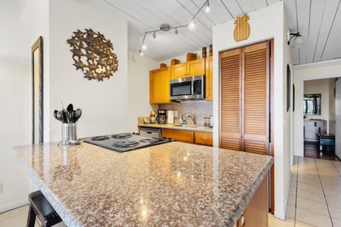 kitchen area with washer and dryer located inside the shutter doors