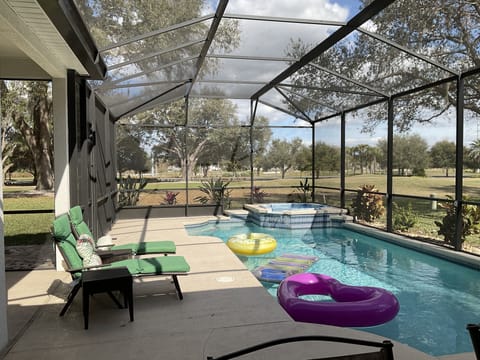 Large pool/spa - Table 5 chairs 2 lounges, bar, refrig, pool floats etc
