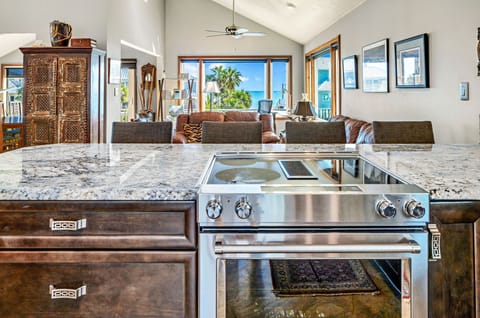 Kitchen features a down draft stove with a spectacular view.