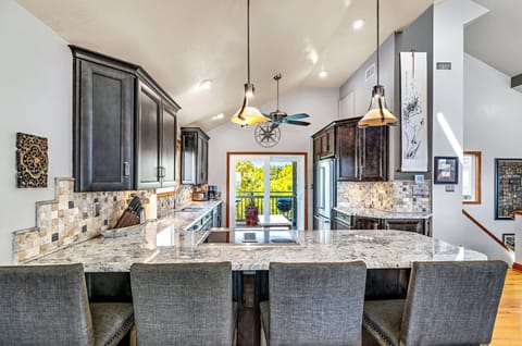 Kitchen features stainless steel appliances and deck access