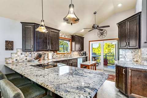 Well-equipped kitchen with bar seating for six.