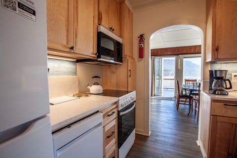 Kitchen with dining area behind it.