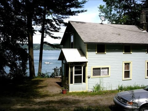 Rear view of Twin Pines w/parking behind cottage and Cayuga Lake to the east.