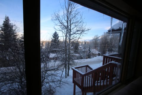 Looking out of living room onto town and front entrance stairs.