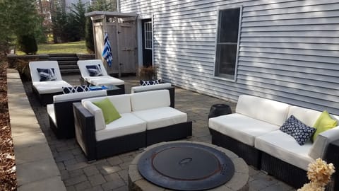 Private setting. This patio, with fire pit & outdoor shower, overlooks woods