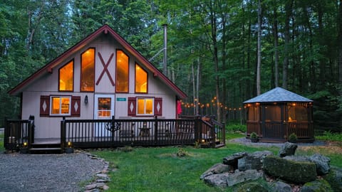 The Chalet in evening time, with gazebo and party lights.