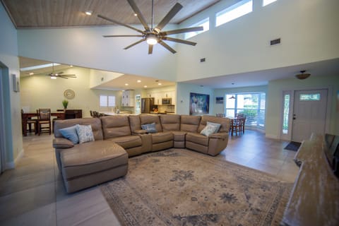 Directly ahead, the living room unfolds with airy and welcoming ambiance.