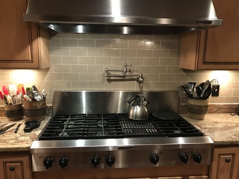 KitchenAid  Pro 6 burner gas cooktop with double grill with water faucet access.